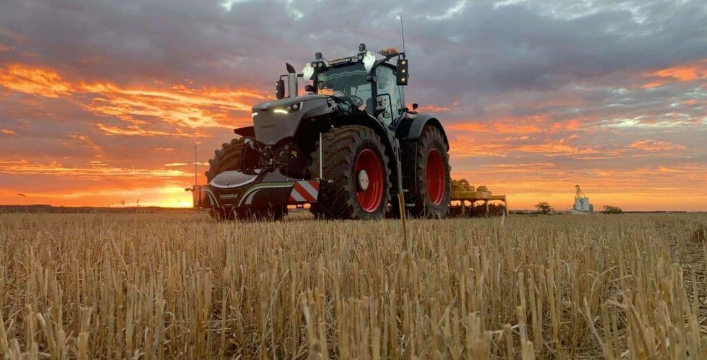 Tractor in a field at sunset